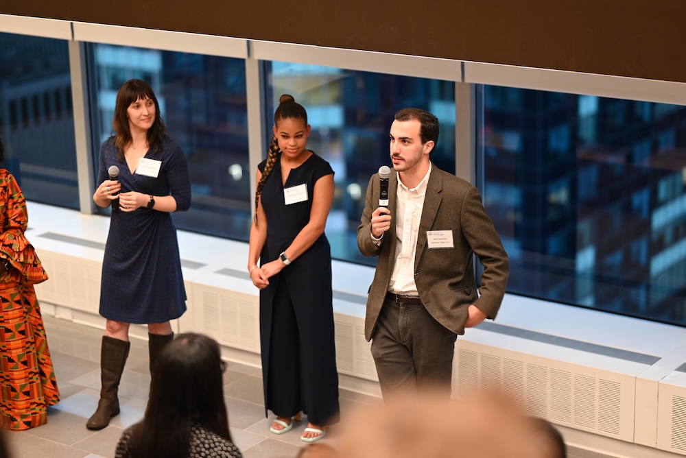 Three individuals speak in front of a window at an event at Paramount Studios